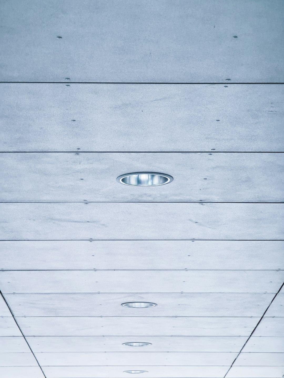 Wood plank ceiling with integrated lighting